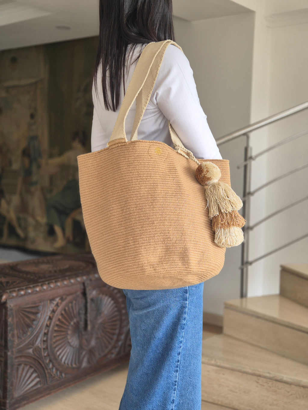 Dark beige handbag with light beige handle and light and dark beige pompom