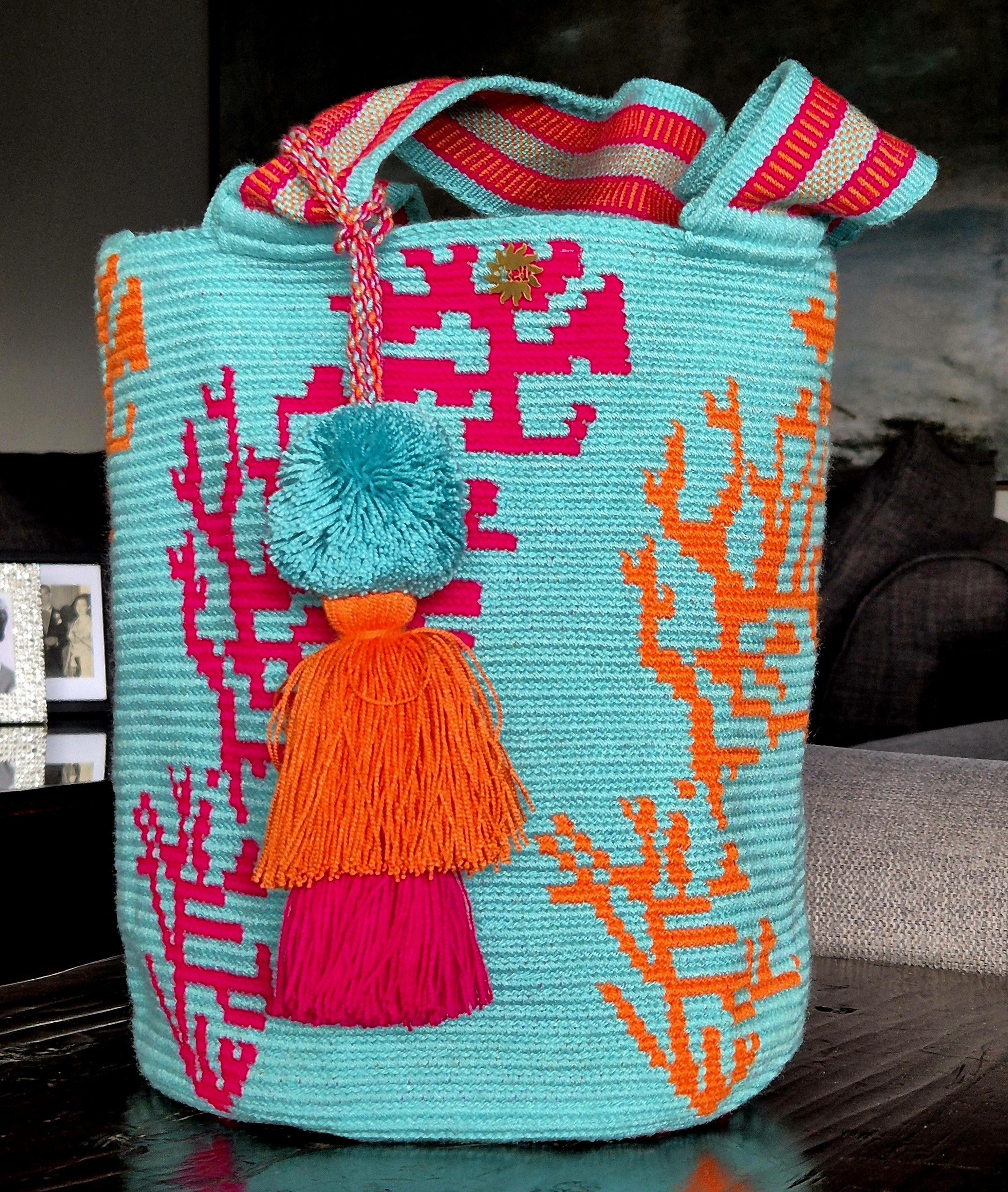 Turquoise blue wallet with a coral pattern in fuchsia and orange