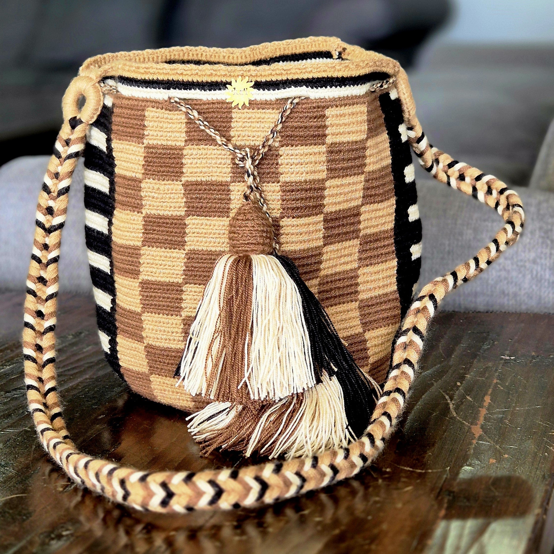 Khaki and brown plaid wallet with black side rectangles with white lines