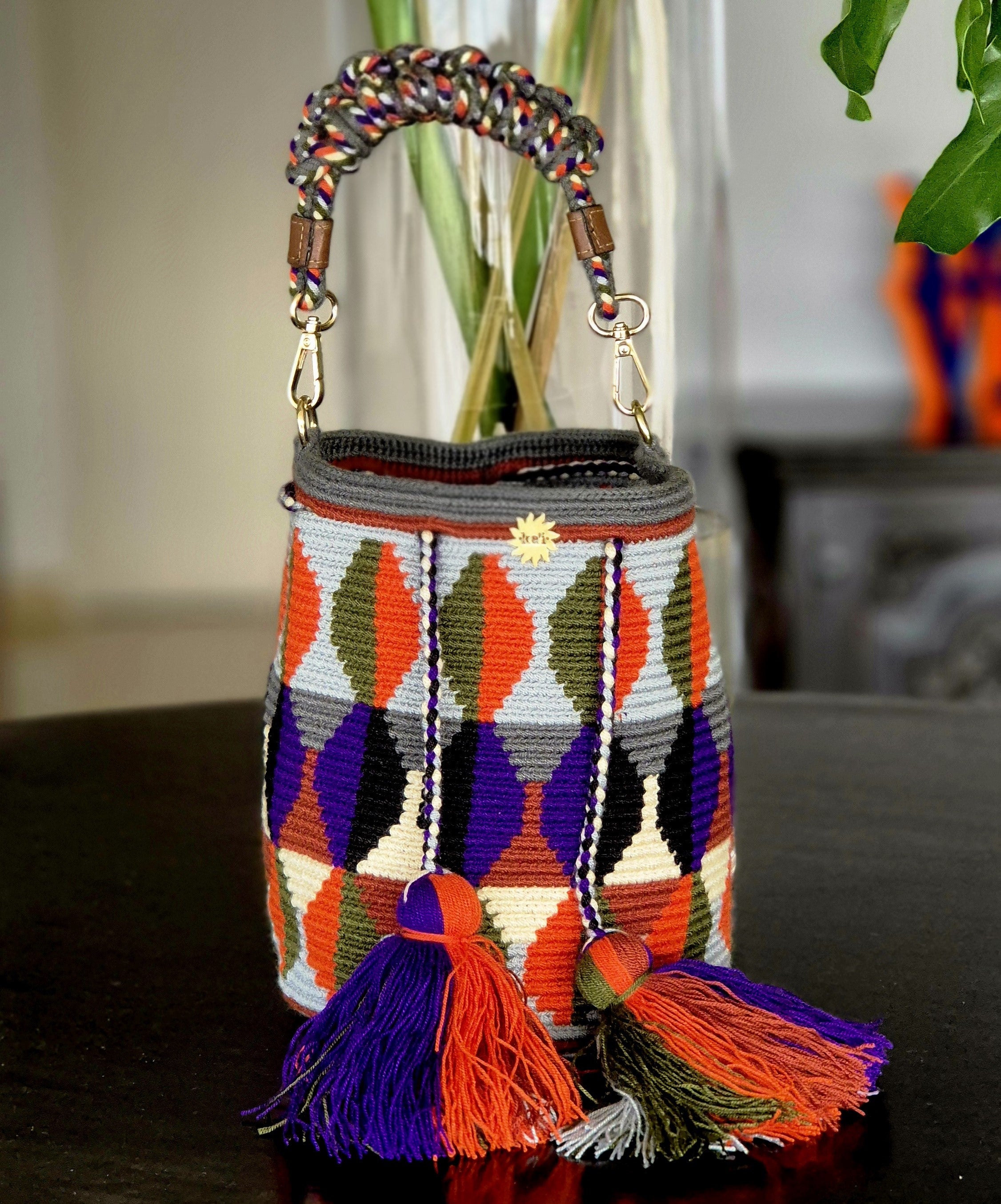 Grey bag with two-tone ovals in olive and orange, black and purple, terra and beige, and dark grey