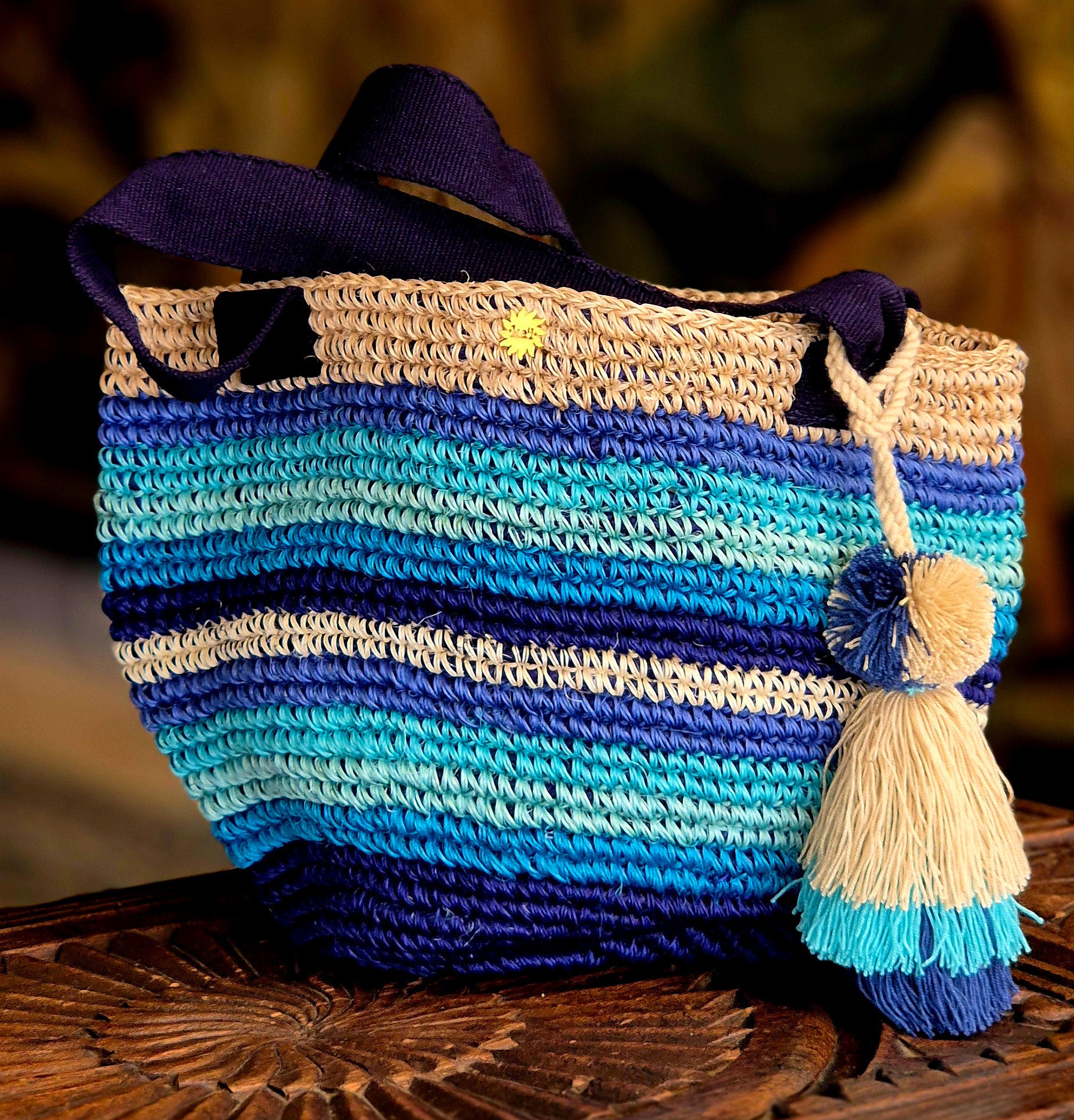 Beige basket with horizontal bands in various shades of blue