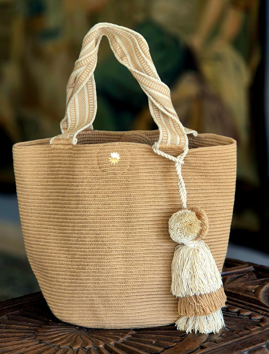 Dark beige handbag with light beige handle and light and dark beige pompom